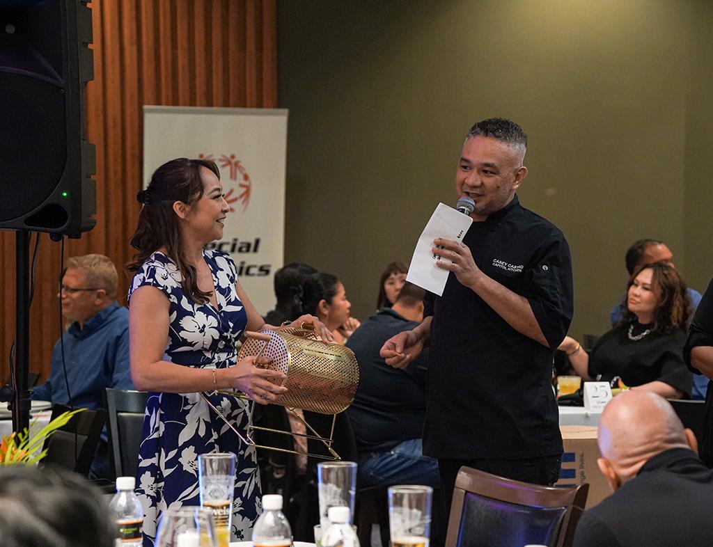 (From left) Valerie Carbullido, director of sales and marketing of Sentry Hospitality, and Casey Castro, executive chef of Capitol Kitchen, selecting the last raffle winner of the evening.